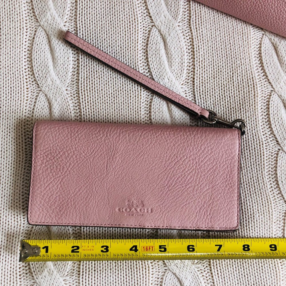 Bifold wallet with detachable wristlet strap.